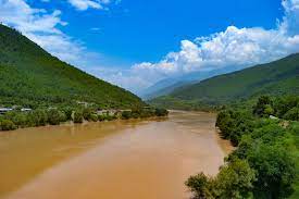 A river is a stream of water that flows through a channel in the surface of the ground. River Britannica