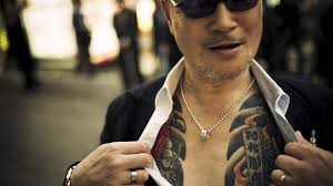 There is a rich history to these tattoos and cherry blossoms and beams of light cutting through thick black and grey lines are typical background imagery used to help fill in the large spaces. Tattoos In Japan Why They Re So Tied To The Yakuza Bbc News