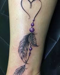 This tattoo consists of a back inked patterned feather with a different small design made in the feather. Pin On Tattoos
