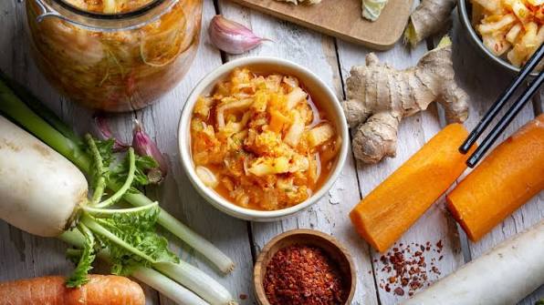 A small bowl of spicy traditional Korean fermented kimchi garnished with sesame seeds