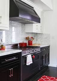 In this stylish kitchen, the main color of the cabinet is black which is accompanied with the light brown and white marble wall. Black And White Kitchen Contemporary Kitchen Lonny Magazine