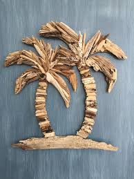 It is a wall hanging depicting a. Driftwood Palm Trees Coastal Tropical Wall Decor Driftwood Diy Driftwood Art Driftwood Decor