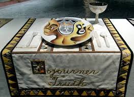 Thirteen place settings are on each side (48 feet long) of a triangular table draped with a white felt. Judy Chicago The Dinner Party Article Khan Academy