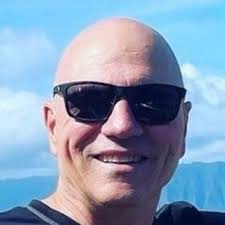 What is the purpose of the part mounted to the left carb