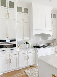 Top mount freezer and full refrigerator in white. White And Gold Kitchen Taryn Newton