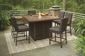 For comfortable seating around a circular fire pit, choose a curved bench seat.for a rectangular or square fire pit, straight benches provide symmetry. Paradise Trail Medium Brown Outdoor Square Bar Set With Fire Pit From Ashley Coleman Furniture