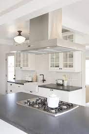 The zline 597i is a professional island mount stainless steel hood with remote blower. Black And White Kitchen With Stainless Steel Hood Over Island Transitional Kitchen White Kitchen White Modern Kitchen Island With Stove