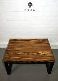 The 4 tapered wooden legs are stained in an espresso finish. Zebrawood Coffee Table Coffee Table Zebra Wood Table