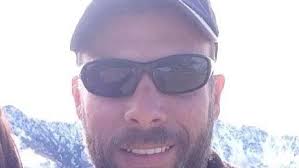 Firefighter dies after being trapped in wind-fueled blaze