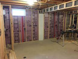 Typically, finishing a basement means adding insulation and drywall over the existing cinderblock or concrete walls. How To Finish A Basement On A Budget Revival Woodworks Basement Remodeling Basement Remodel Diy Finishing Basement