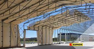 Capannoni mobili e coperture, sistemi di carico e chiusure industriali. Kopron Capannoni Coperture Baie Di Carico Portoni Industriali