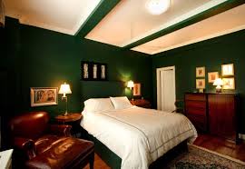 If you decide to go dark on your bedroom walls but don't want an especially modern feel, choose natural or painted wooden furniture rather than metal. Bedroom With Dark Green Wall And Dark Brown Wood Furniture Architecture Interior Design