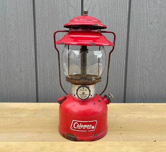 The iconic vintage gas lantern—a symbol of traditional camping culture.，AI 生成