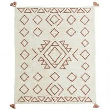 Hanging tassels near the top of the ceiling draw the eye upward without populating the rest of the room and making it messy. Madam Stoltz Htufted Cotton Rug With Tassels Orange Off White