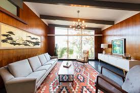 Exposed beams and a focus on materials such as the tile fireplace surround. Tour A Unique Mid Century Renovation In Oregon Home