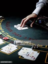 Male Croupier Resting Hand On Upturned Cards On Gaming Table Table Games Cards Gambling Humor