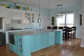 White Kitchen Cabinets With Teal Island Grey Quartz Countertops Antique Bronze Light Fixtures And Hardw Teal Kitchen Teal Kitchen Cabinets Teal Kitchen Decor