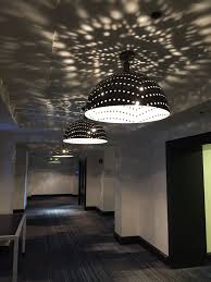Custom Lighting Playing With Light And Shadows Peforated Pattern Is A Small Detail To Make A Big Impact Hotel Lighting M Custom Lighting Lighting Light