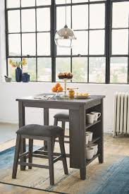 These tables are generally around 36 inches in height while the chairs can be around 41 inches tall while being able to seat between 4 to 10 people. Caitbrook Gray Rectangular Counter Table Set 3 Cn On Sale At American Furniture Of Slidell Serving Slidell La