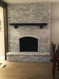 Black And White Fireplace Surround Whitewashed Fireplace With Black Mantel Black Brick Fireplace White Painted Fireplace Brick Fireplace Makeover
