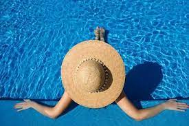 Woman In Hat Relaxing At The Pool Photographic Print Haveseen Art Com In 2021 Summer Glow Best Tanning Lotion Perfect Summer