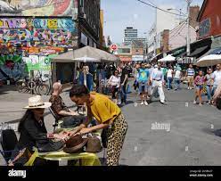 Torontos Kensington Market street bazaar attracts large crowds of  interested visitors to see its vintage goods and exotic foods Stock Photo -  Alamy