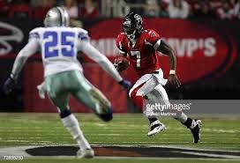 Quarterback Michael Vick Of The Atlanta Falcons Runs The Ball Against Patrick Watkins Of The Dallas Cowboys At The Georgi Cowboys Vs Falcons Cowboys Vs Cowboys