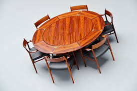 Like a magic trick, these hidden leaf dining tables seem to grow before your eyes. Dyrlund Extendable Rosewood Dining Table Denmark 1962 Massmoderndesign