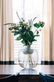 Simple Modern Dining Table Centerpiece Oversized Clear Glass Vase With Greenery In 2020 Dining Table Centerpiece Modern Dining Table Clear Glass Vases