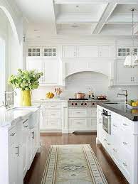 A traditional touch to the classic white and gray brings the fun, and joyful elements of a farmhouse look to a more sophisticated, yet inviting kitchen interior. White Cottage Kitchen Ideas Cottage Kitchens Cottage Style Kitchen White Cottage Kitchen