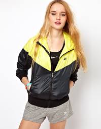 Nike windbreaker yellow nike windbreaker jacket, pockets zip up, has reflective lining, nike logo on front and the word nike on the back. Yellow And Black Nike Windrunner Rain Jacket Shiny Nylon