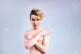 Naked Shirtless Non Binary Portrait Of Asian Man With Luxurious Blonde Hair  And Gorgeous Make-up In White Wall Studio Background Stock Photo, Picture  And Royalty Free Image. Image 165392109.
