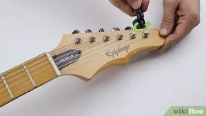 Using your wire cutters, cut the loose strings around the sound hole. How To Change Strings On An Electric Guitar 15 Steps