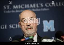 In this Monday, Nov. 19, 2018 photo, Larry Sprowls, a former mayor of  Claysville, shows Fred Gashel, far left, and his brother Wilbur, second  left, the name of their father written on