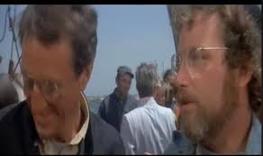 Why does Hooper contradict himself when catching the tiger shark in Jaws?