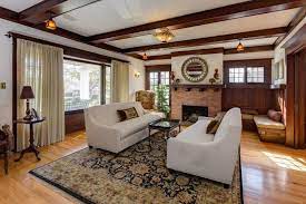 The interior of the door is painted turquoise to match the exterior and bring a hit of colour into the neutral foyer. Real Estate Listings Craftsman Living Room Craftsman Living Rooms Craftsman Home Interiors