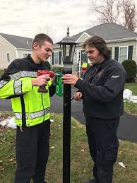 Lakeville firefighters install address numbers at Wood's Edge neighborhood