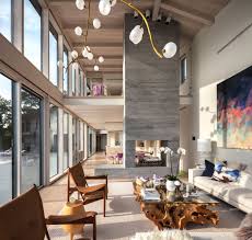 A Monumental Board Formed Concrete Fireplace Separates The Living Room From The Kitchen And Dining Area But Is Open To Both Sides Glass House Design Modern Glass House House Paint Interior