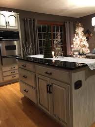 Besides painting my cabinets, they added two cabinets into my back wall configuration and another cabinet into my existing island. Kitchen Cabinet Refinishing Before After