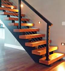 The dark color matches other black metal furnishings and stands out nicely against an earthy backdrop of stone and wood. Stair Railing Ideas