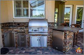 Our modern custom outdoor kitchens are made of luxurious stainless steel and glass cabinets, countertops and more—customized around the specs of your grill and other outdoor appliances. Custom Outdoor Kitchens Concrete Construction Outdoor Contractor Custom Outdoor Kitchens Fire Pits And More Concrete Construction