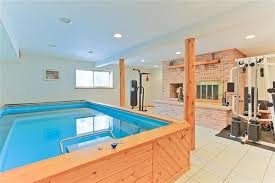 A Basement Renovated Into A Versative Endless Pool Fitness Room Endless Pool Pool Houses Small Indoor Pool