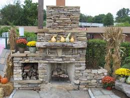 A stone fireplace, while classic and timeless, can be easily elevated to revive your home. Outdoor Stone Fireplace Warming Up Exterior Space Homedecorite