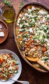 Place the remaining salmon on top, squeeze the roasted lime half over the dish, then garnish with the scallions, remaining feta, parsley and mint. Pearl Couscous With Creamy Feta And Chickpeas Recipe Recipe Couscous Recipes Pearl Couscous Recipes Chickpea Recipes