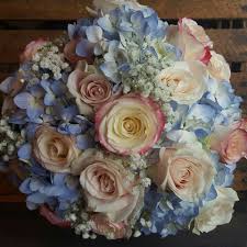 Two of nature's most radiant botanical creations.roses and hydrangea.blend together in harmonious beauty with hypericum in this stunning bouquet set in a pretty container. Baby Blue Hydrangea And Pink Rose Bouquet Pink Rose Bouquet Blue Hydrangea White Roses