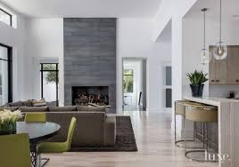 Grey Slate Fireplace With Green Chairs Wood Floors White Walls And A Breakfast Bar Modern White Living Room Popular Living Room Living Room Modern