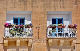 Real photo of a rattan garden furniture set with lamps and table in the background. Houses With Balcony In Malta Stock Image Image Of Colorful Rabat 169186641