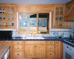 The Black Hardware And Blue Counter Make This Look A Little More Modern Pine Kitchen Cabinets Knotty Pine Kitchen Kitchen Cabinets