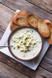 A Creamy Soup Flavored With Garlic Artichoke Hearts Parmesan Cheese Cream Cheese And Cayenne Pepper Artichoke Soup Creamy Spinach Recipes