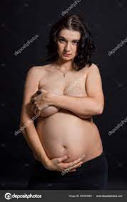 Pregnant Woman Posing Nude Cupping Her Large Swollen Abdomen Tenderly Stock  Photo by ©YAYImages 259164960